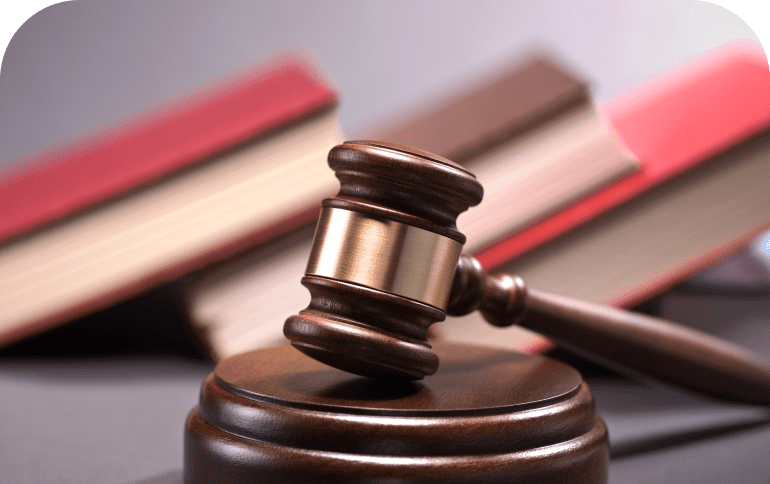 Gavel with law books in background.